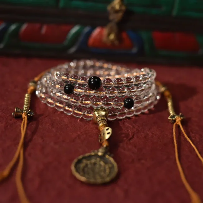 Hand-tied blessing knot on Himalayan clarity mala